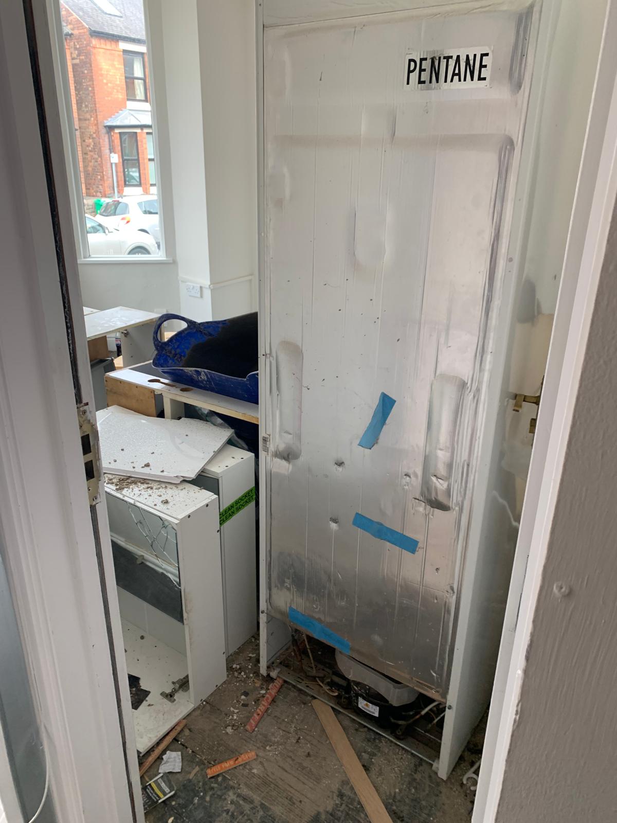 Fridge unit showing official Pentane environmental hazard label