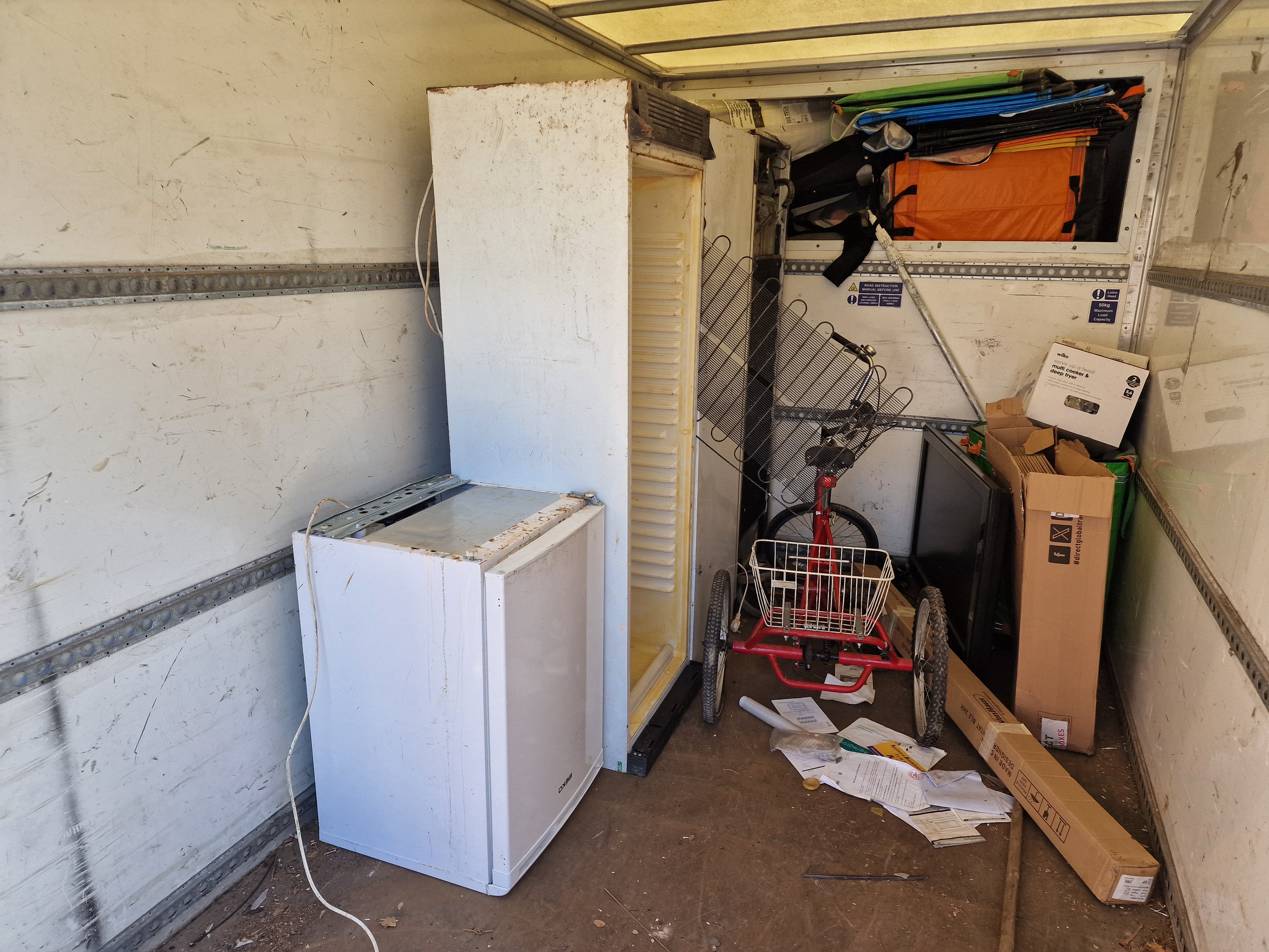 Licensed waste carrier van loaded with refrigerators for recycling